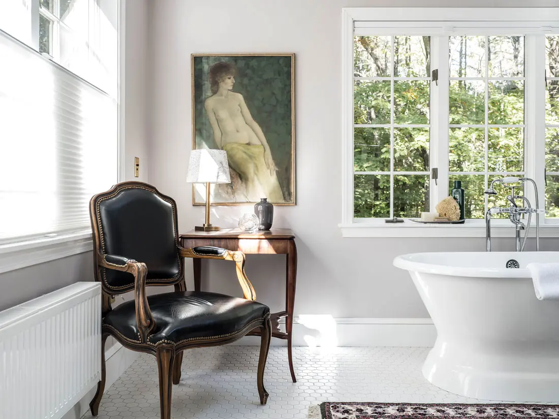 In a first-floor bath furnished with a soaking tub and a painting from South Portland’s Barridoff Auctions, classic hex tile feels mod in a two-inch width.