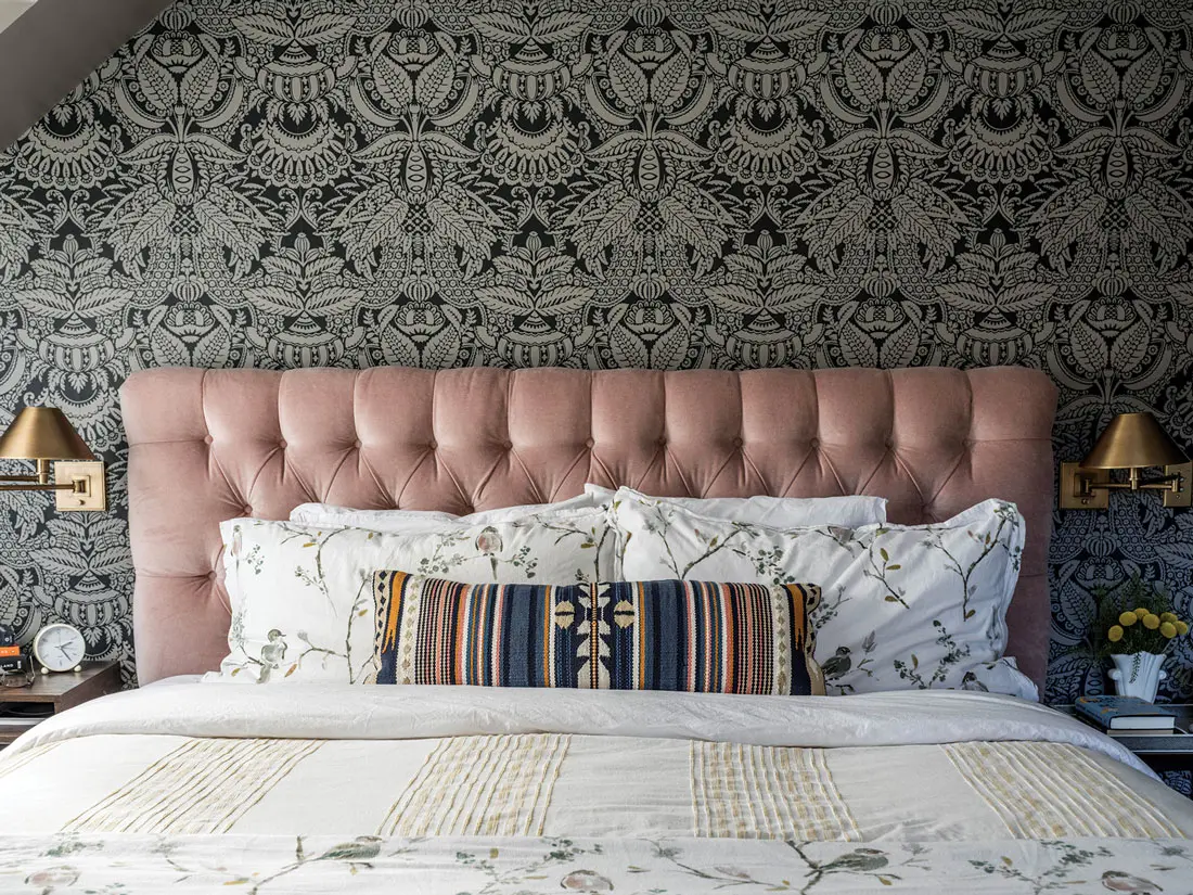 A photo of an English country house inspired the primary bedroom’s Farrow & Ball Orangerie wallpaper and tufted headboard from Bloomingdale’s.