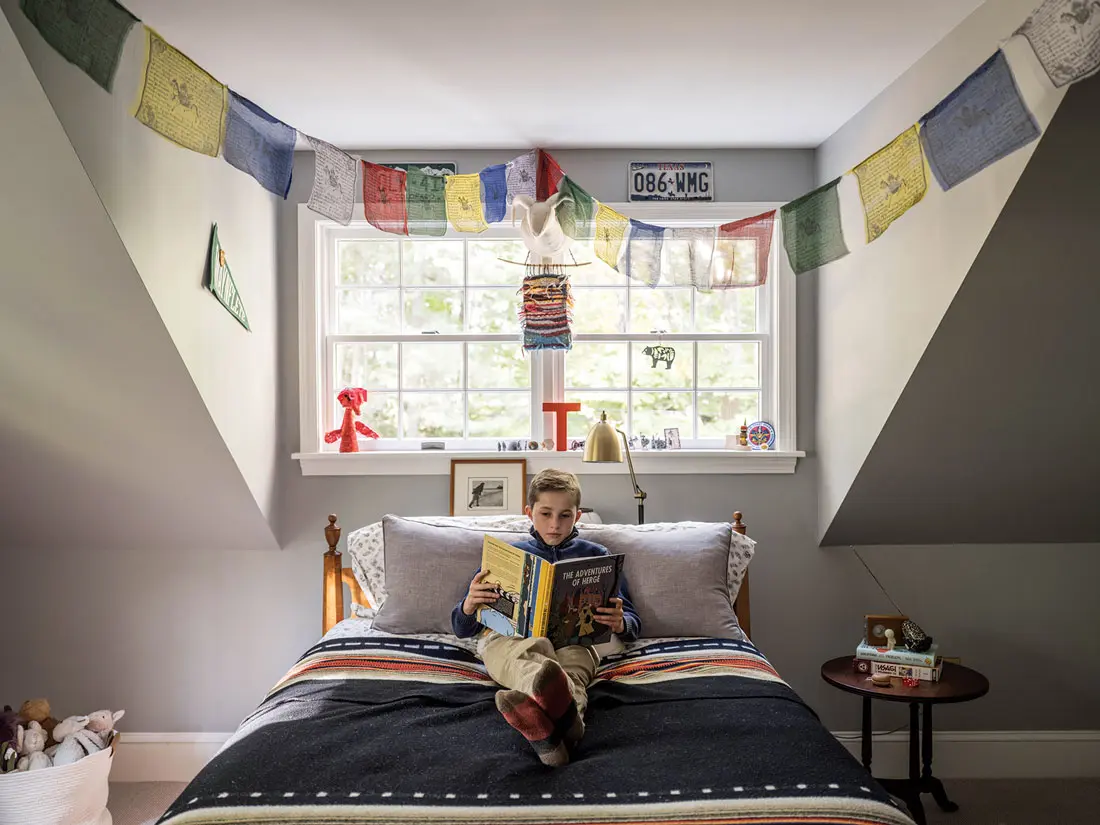 Thirteen-year-old Tommy kicks back on his great-grandfather’s maple bed, topped with a Pendleton blanket