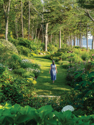 Swaths of summer bloomers, such as astilbes, coneflowers, heleniums, hydrangeas, and phlox, color Elsie Freeman’s shore-front borders
