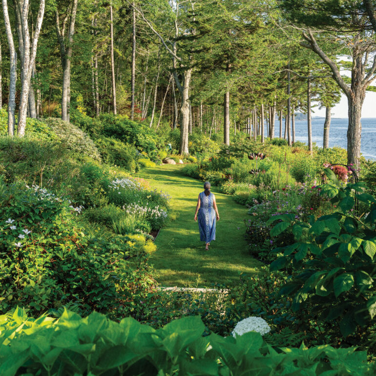 Swaths of summer bloomers, such as astilbes, coneflowers, heleniums, hydrangeas, and phlox, color Elsie Freeman’s shore-front borders