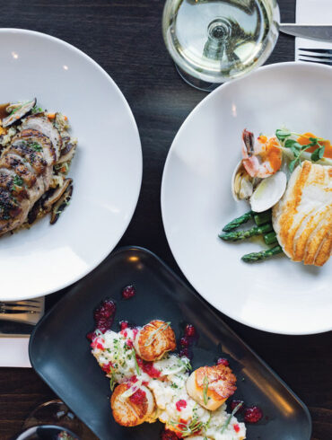 Alstation Station's seared Maine dayboat scallops with cranberry risotto and cranberry-orange relish; duck breast à l’orange with shiitake mushrooms and quinoa pilaf; pan-roasted Maine halibut in a bouillabaisse sauce.