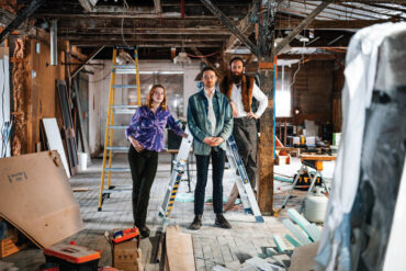 Lights Out Gallery founders Karlë Woods, Reed McLean, and Daniel Sipe in an under- construction studio
