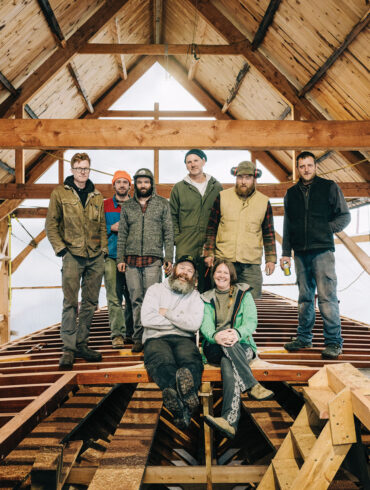 Josh Rowan and Erin Desmond (seated), in Thomaston with the crew restoring their historic schooner Hindu