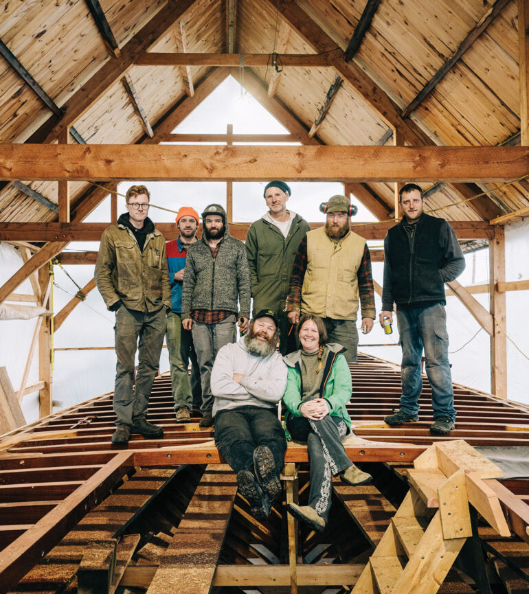 Josh Rowan and Erin Desmond (seated), in Thomaston with the crew restoring their historic schooner Hindu