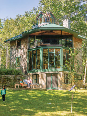 the three-sided, glass-walled bump-out of jeweler Aaron Ruff’s multifaceted Arrowsic home