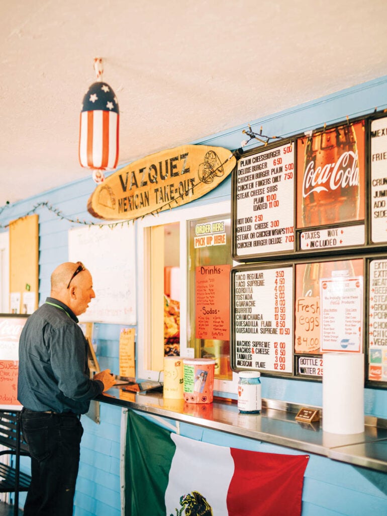 man ordering at the counter of Vazquez Mexican Takeout in Milbridge, Maine
