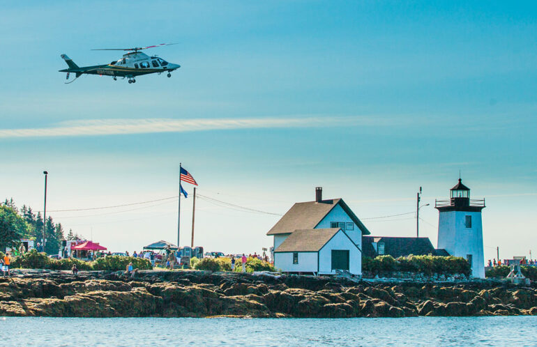 LifeFlight of Maine helicopter hovering over Grindle Point Lighthouse