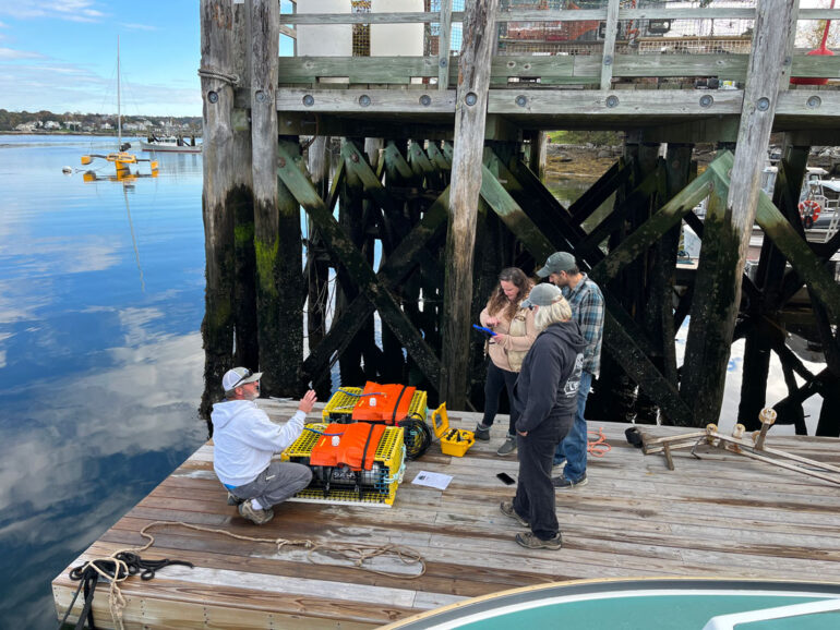 man demonstrating how to use “ropeless” lobster traps