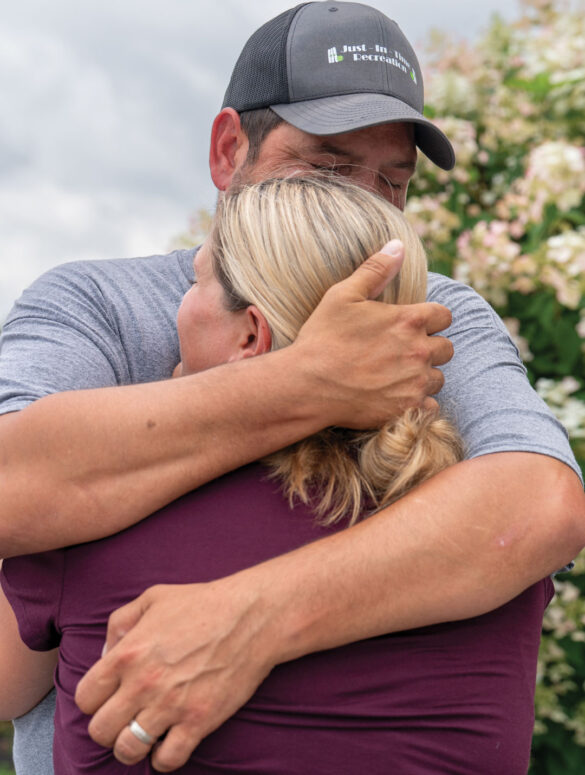 Justin and Samantha Juray, the owners of Just-In-Time Recreation, embracing.