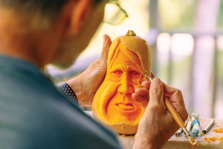 William Janelle carving a face on a gourd