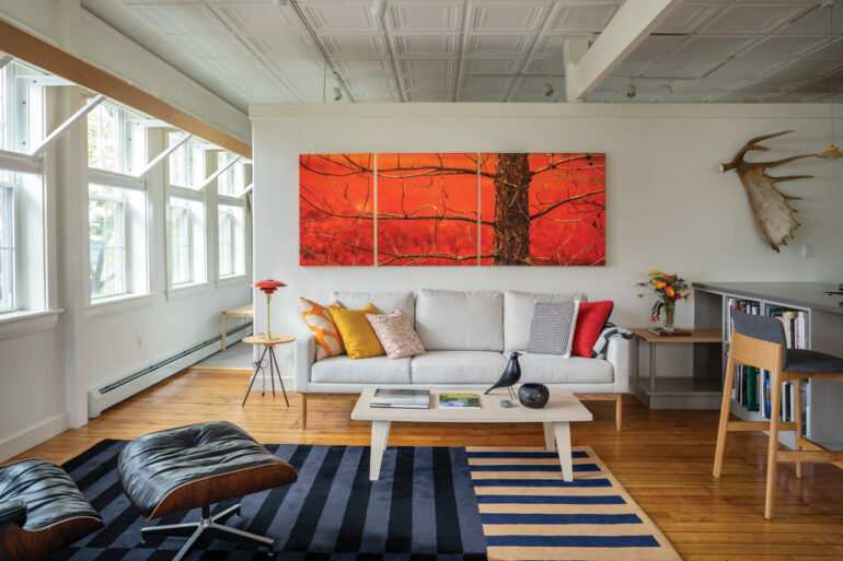 Above a Design Within Reach sofa, the branches on a spindly pine in the Orcutts’ triptych of a fiery-red blueberry field echo the branches on a moose antler John and his son found while cross-country skiing in Carrabassett Valley