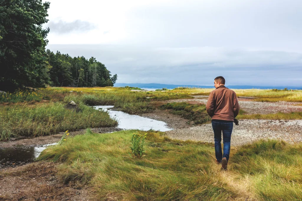 Chris Buchanan walks along the island’s northwest shore, an area threatened by the proposed port.