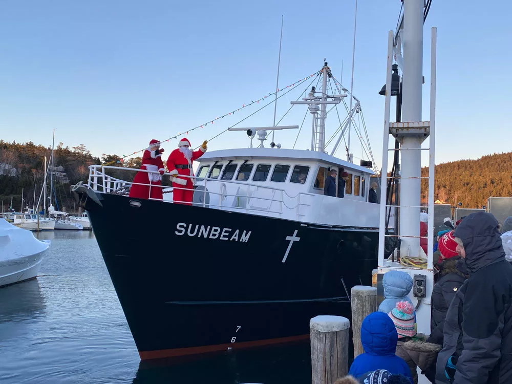 Santa and Mrs. Claus arriving on the Sunbeam at the 2024 Northeast Harbor Christmas Festival