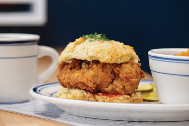 Buttermilk Kitchen's signature chicken biscuit with red-pepper jelly and house-brined pickles. 