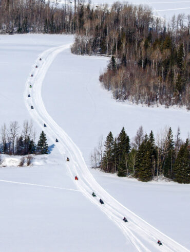 snowmobilers riding on Maine's Interconnected Trail System