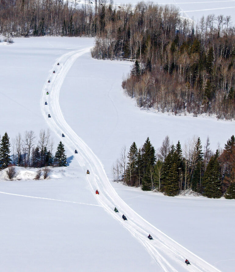 snowmobilers riding on Maine's Interconnected Trail System