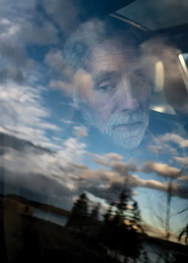 writer Joseph Monninger looking out a car window