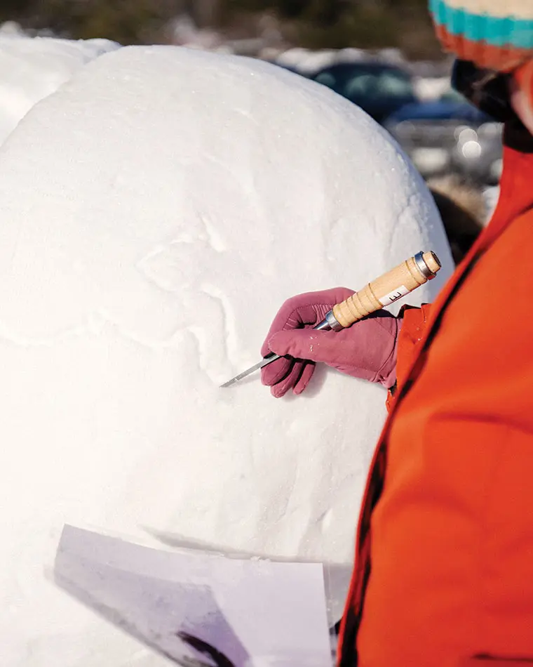 The Chickadees, Maine's all female snow-sculpting team working on their practice snow-sculpture of Artemis in Waterville Maine