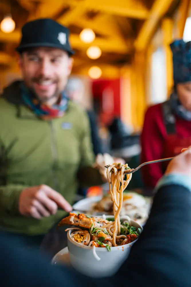 people eating bowls of noodles at The Nest