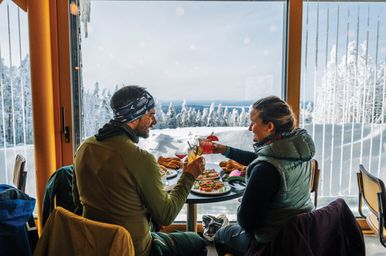 a couple enjoying a meal and the view at The Nest on Saddleback Mountain