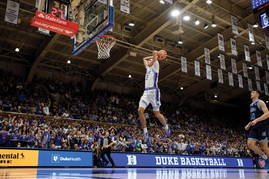 Duke's Cooper Flagg dunks on a fast break during the second half of an NCAA college basketball game against Maine in Durham, N.C.,