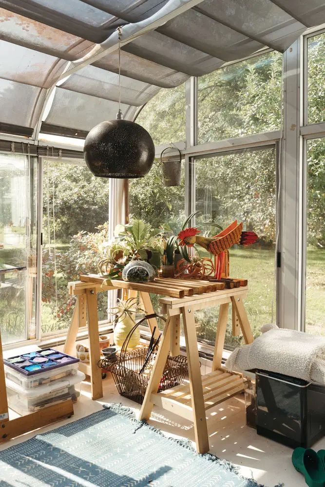 A perforated-metal World Market pendant effects a contrasting (or coordinating) starry sky in the sunroom.
