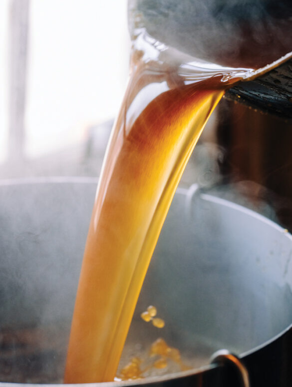 syrup pouring into a vat