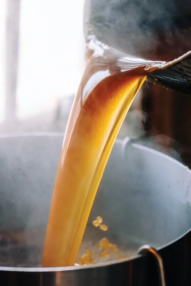 syrup pouring into a vat