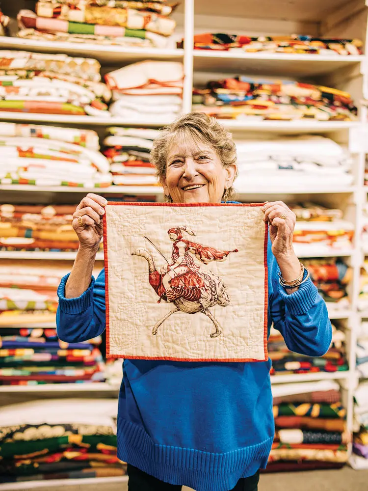 Betsey Telford-Goodwin holding a quilted square