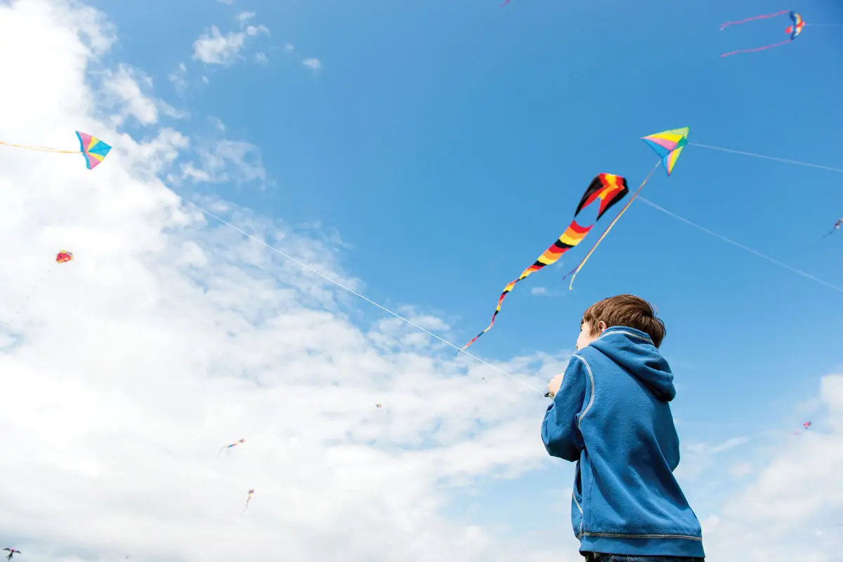 child flying a kite