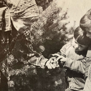 Jerry Elwell shows two children the injured bird in her hand