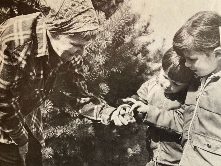 Jerry Elwell shows two children the injured bird in her hand