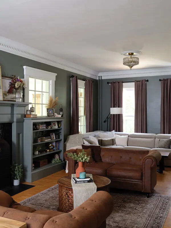 Attitude Gray by Sherwin-Williams on the walls and woodwork imparts a cozy, den-like vibe in the living room