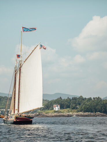 Schooner Stephen Taber sails towards Curtis Island Light, at the entrance of Camden Harbor.