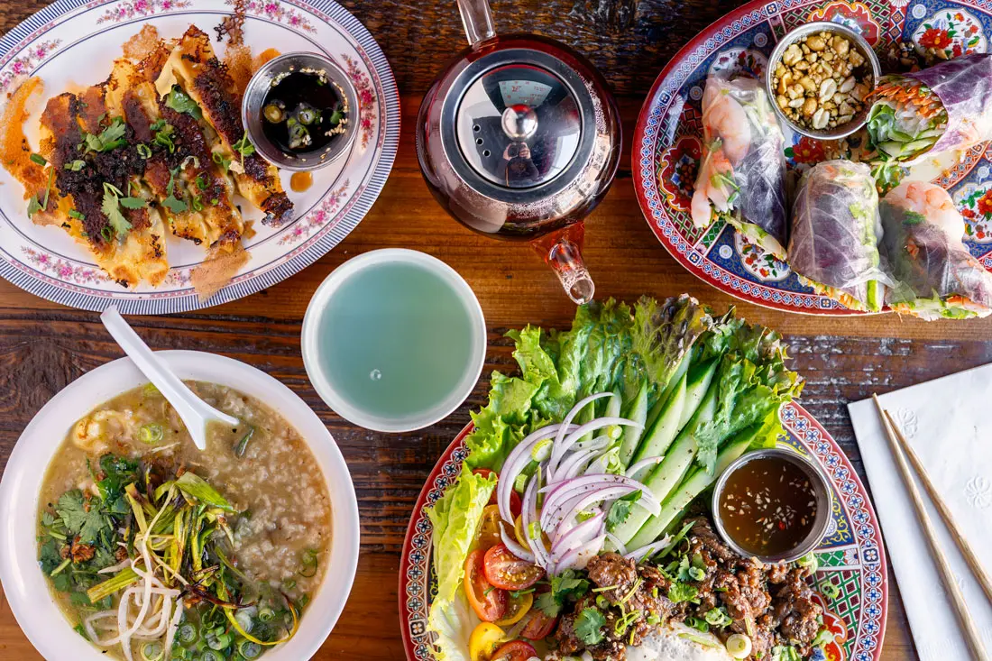 Pork potstickers, shrimp fresh rolls, loc lac, and chicken congee from Oun Lido's in Portland, Maine