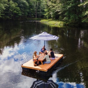 a family sitting on one of Lon Cameron's Maine Float picnic table boats