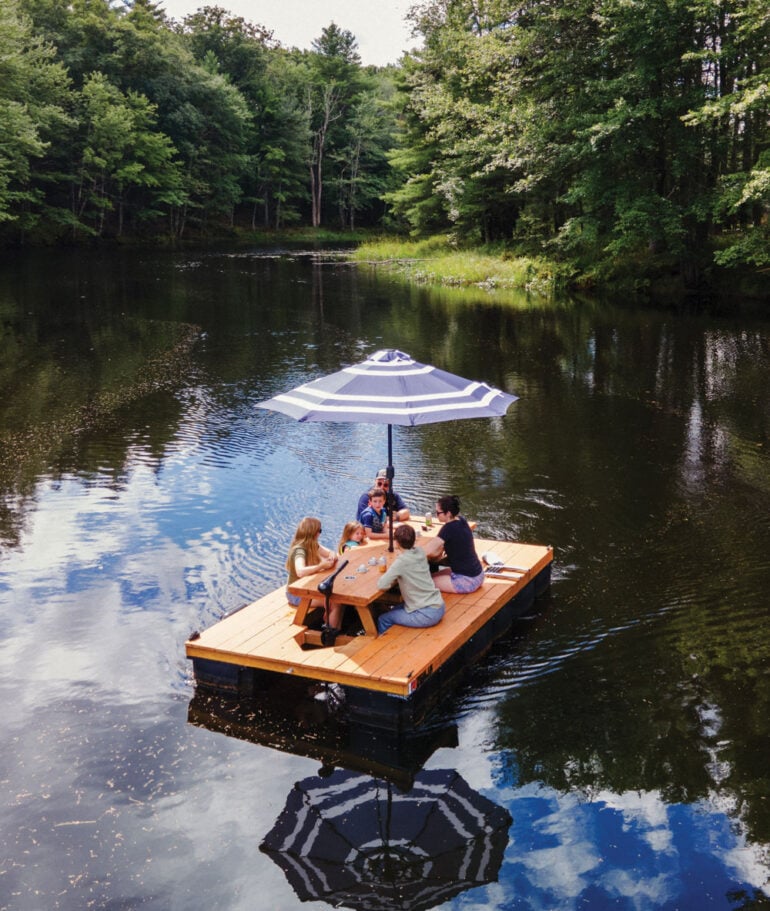 a family sitting on one of Lon Cameron's Maine Float picnic table boats