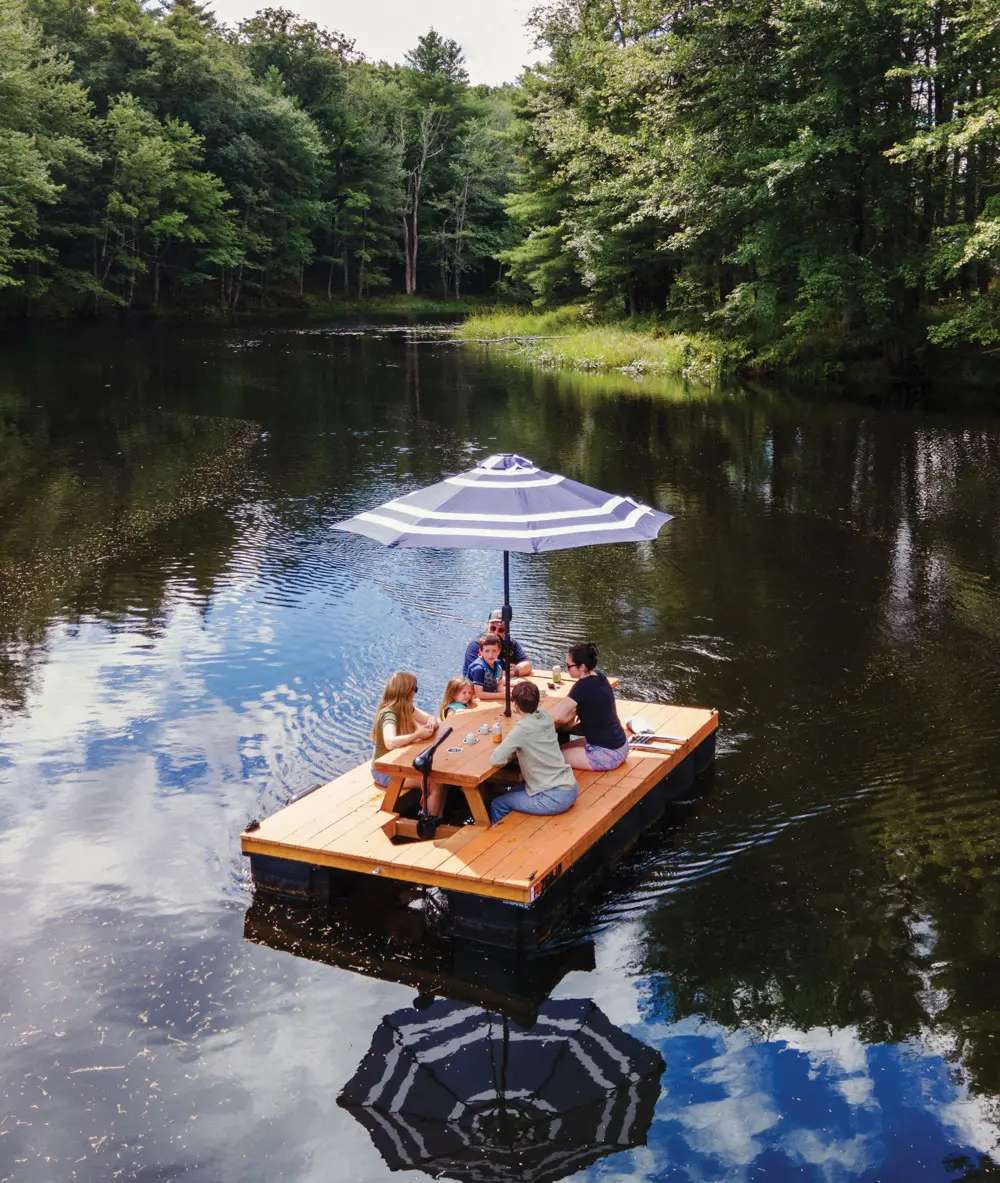 a family sitting on one of Lon Cameron's Maine Float picnic table boats