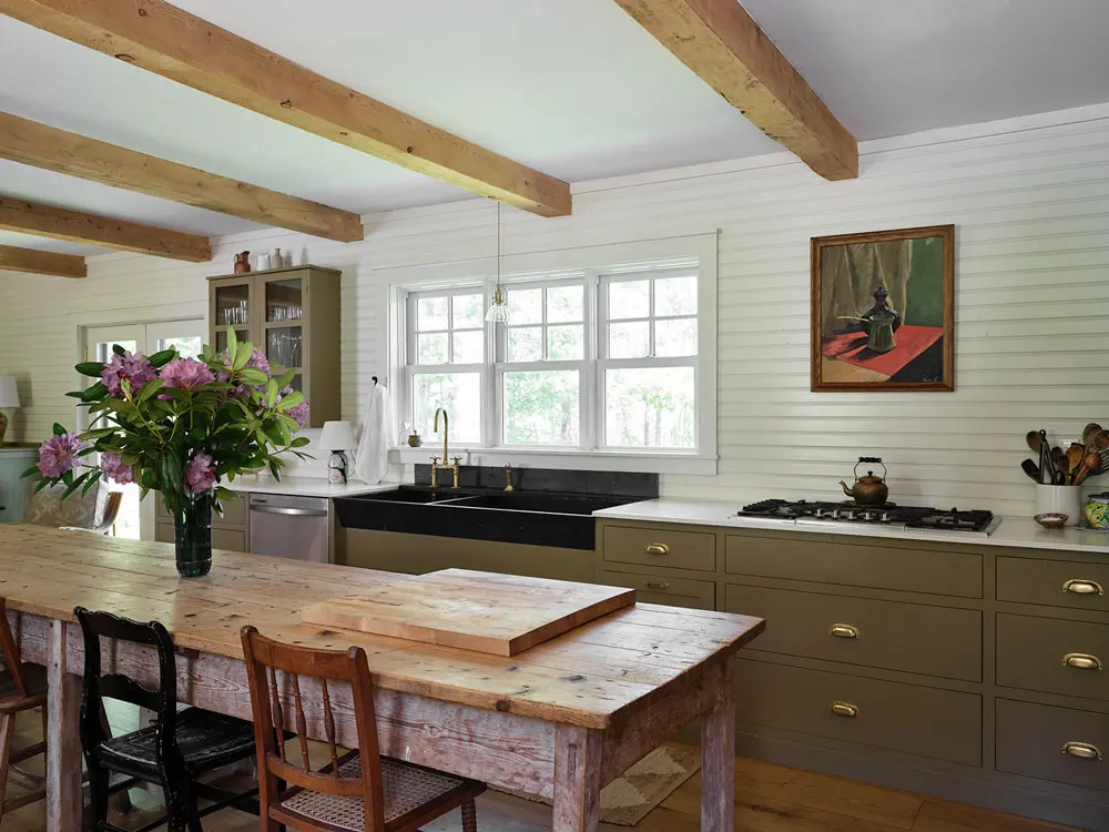 beadboard paneling, a slate sink from Portland Architectural Salvage, and a bank of cabinetry crafted by Gardiner’s Zoulamis Fine Woodworking in the kitchen