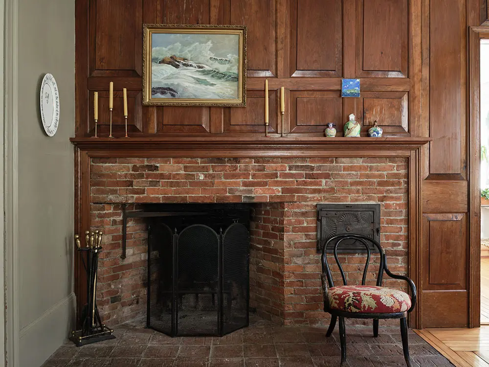a Colonial-style cooking fireplace a previous owner installed in the ’80s and a sea-scape from Woolwich’s Montsweag Flea Market in the dining room