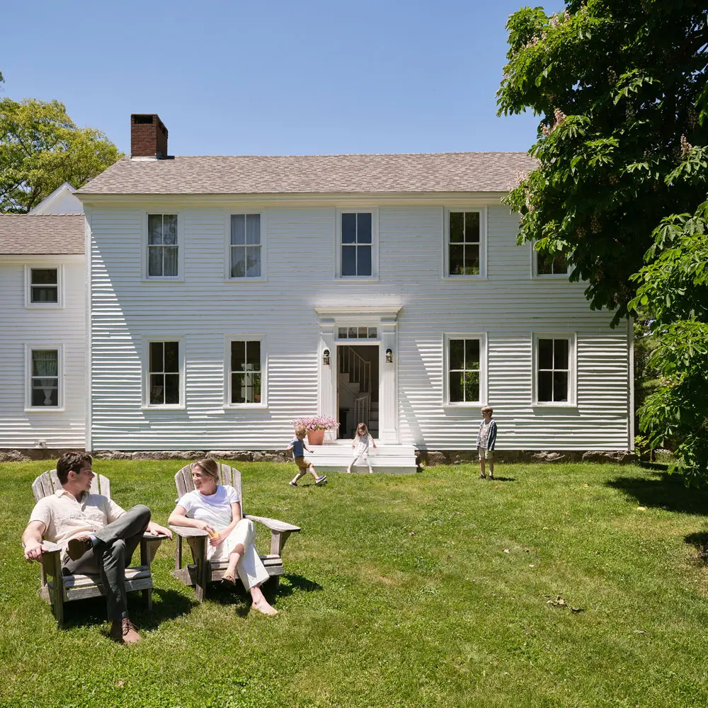 J and Clementine Cavanagh sitting outside of their renovated circe 1790 Federal in Phippsburg Maine