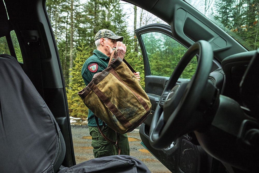 Maine moose biologist Lee Kantar stepping out of his work truck