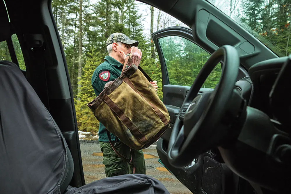 Maine moose biologist Lee Kantar stepping out of his work truck