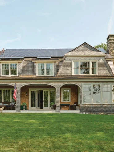 The exterior of Ford and Karen Reiche’s waterfront home, in Freeport, riffs on an 1899 Shingle-style Islesboro cottage designed by famed architect Fred Savage