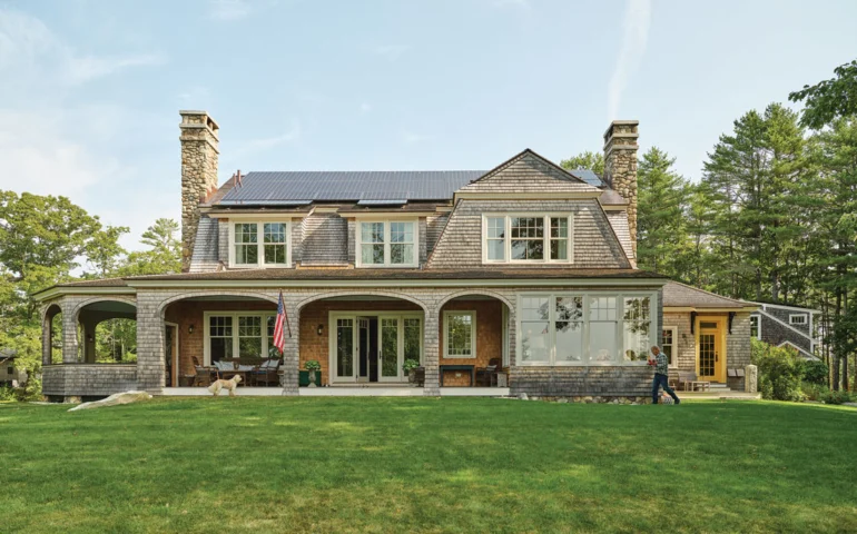 The exterior of Ford and Karen Reiche’s waterfront home, in Freeport, riffs on an 1899 Shingle-style Islesboro cottage designed by famed architect Fred Savage
