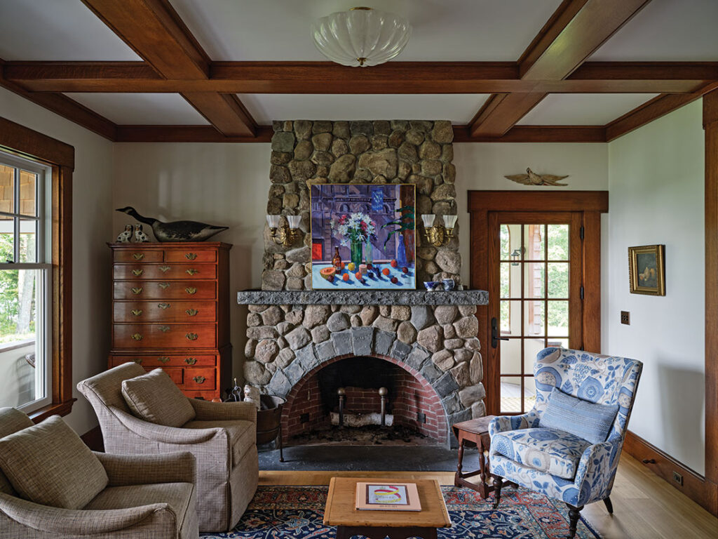 a fieldstone fireplace and a coffered ceiling with painted and stained
moldings in the living room
