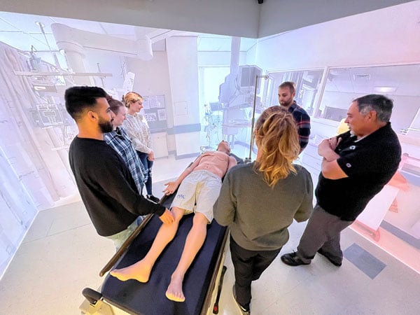 students standing New England’s only state-of-the-art Immersion Suite at the University of Maine at Fort Kent