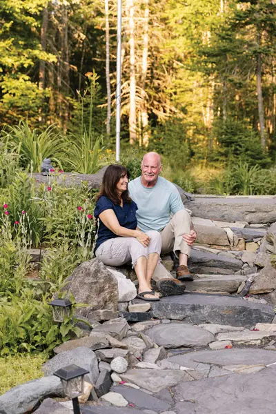 Rick Cochran and his wife, Karen, on the steps of their Greenville rock garden