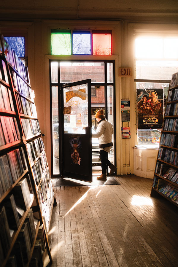 a customer walking out with a DVD from Opera House Video